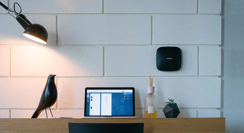 Ajax Hub 2 Plus on a wall above a desk
