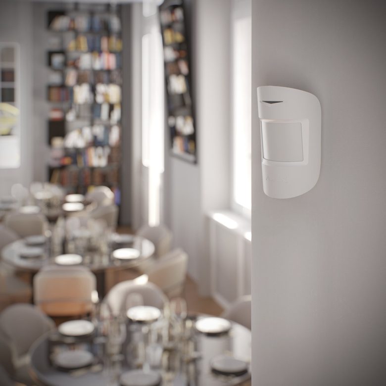 Ajax MotionProtect on a living-room wall